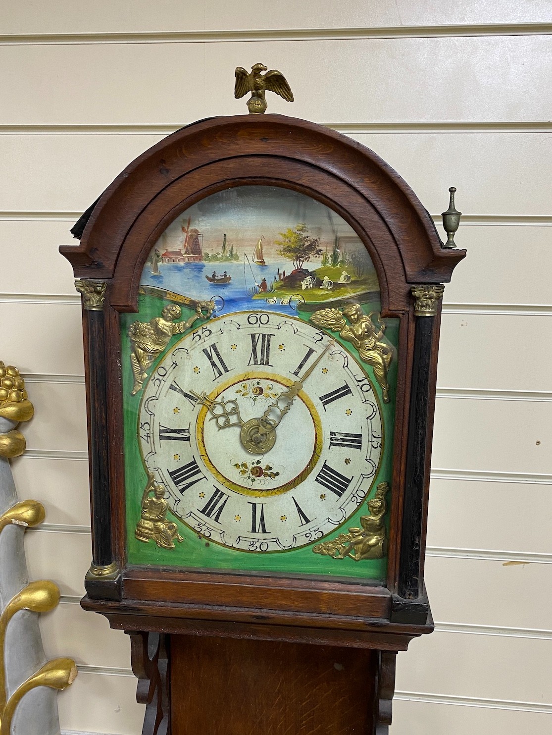 A Dutch oak wall clock with arched painted dial, height 130cm